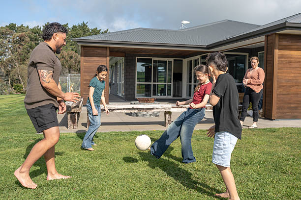 istock Family Playing Soccer Game in Backyard 2237489769