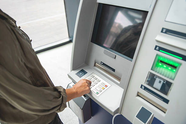 istock Female hand PIN entry at ATM machine 2237489826