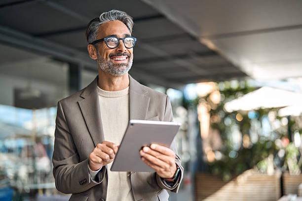 istock Happy middle aged professional business man executive manager using tablet. 2237489948