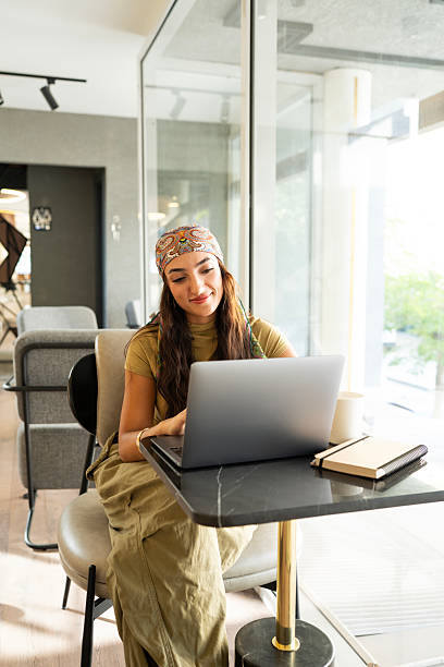 istock Woman freelancer working on laptop in modern cafe 2237490291