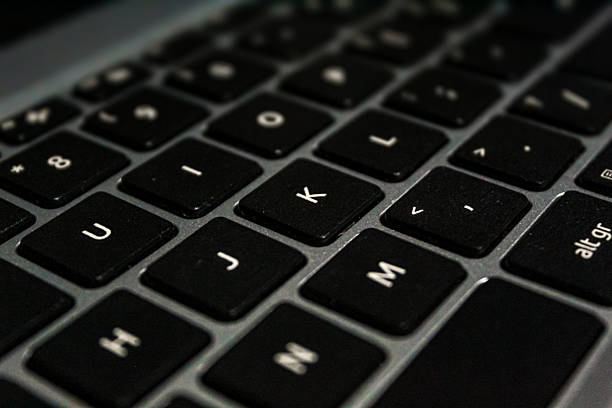 istock Diagonal Perspective of Dark Laptop Keyboard Keys in Low Light 2237490445