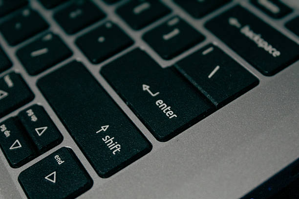 istock Close-up on 'Shift' and 'Enter' Keys of a Dark Laptop Keyboard 2237490463