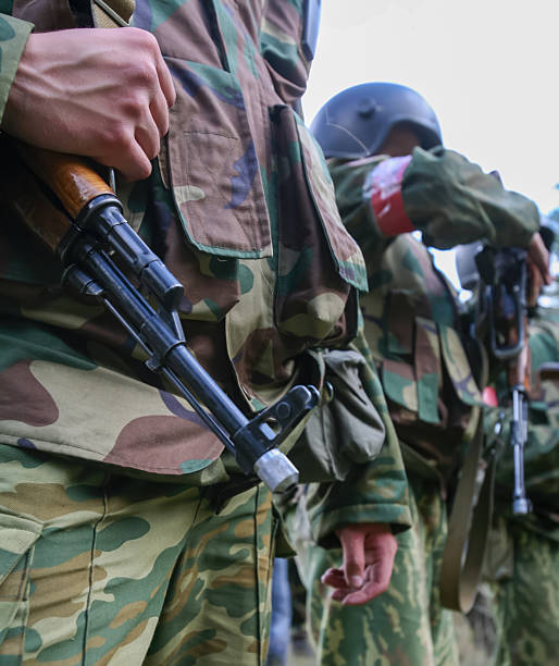 istock Soldiers in camouflage uniforms prepare for a tactical exercise during a training session in the field 2237490546