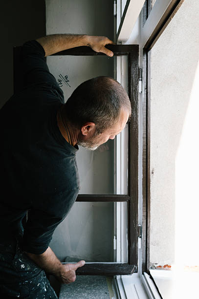 istock labour worker indoors repairs windows in an old empty house 2237493344