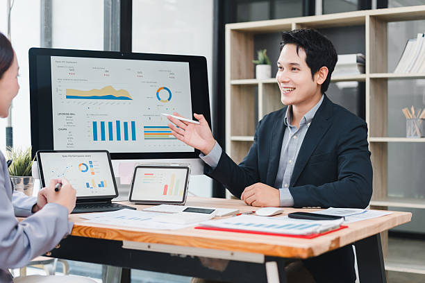istock Businessman presenting dashboard data analysis with charts and graphs on digital devices in modern office meeting, teamwork and collaboration for project success 2237495939