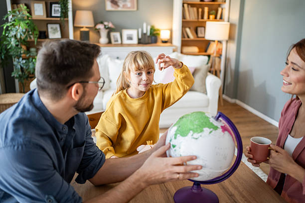 istock Daughter playing with globe learning about geography at home 2237498173