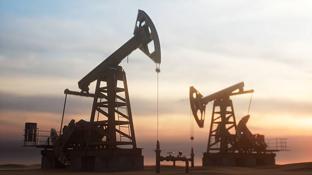 istock Oil pump jacks at sunset 2237498425