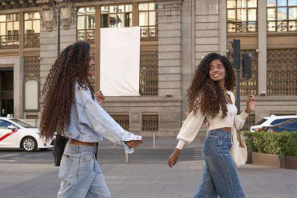 istock Young women friends walking city street smiling 2237498607