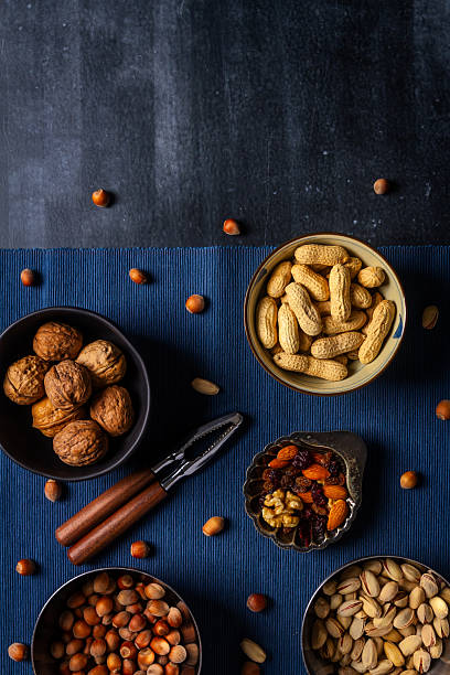 istock Bowls with nuts and blue table cloth on black chalkboard 2237500981