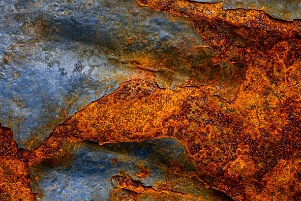 Rusty metal surface with shabby background paint. Blue cracked paint texture on an iron sheet. Fragment of an old metal door, Metal corrosion.