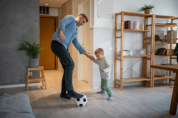 istock Father and son playing soccer, bonding at home 2237501558