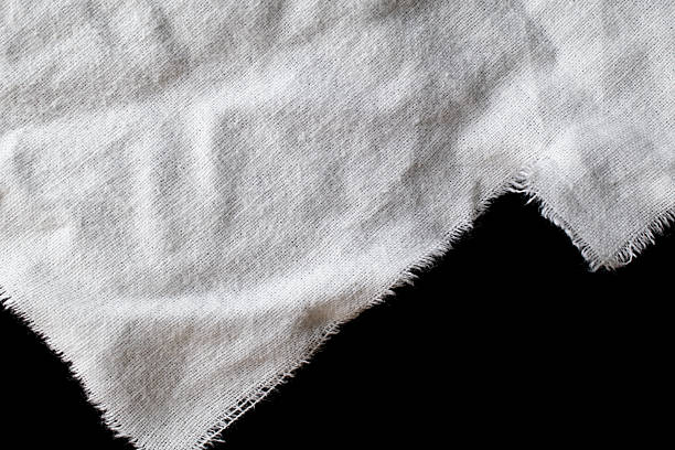 torn old white rag with holes on a black background