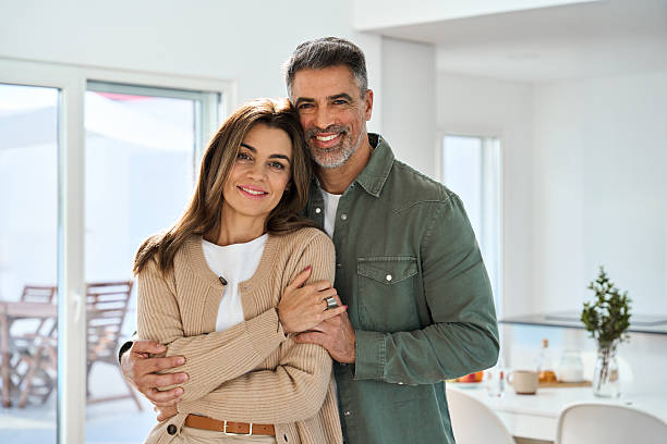 istock Happy mature couple hugging looking at camera standing in kitchen at home. 2237503368