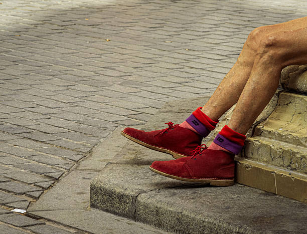 I sit down near the shoes.