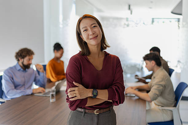 istock Asian female leader smiling at camera – professional confidence and authority 2237508595