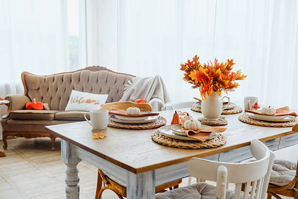 istock Warm autumn dining table setting with pumpkins and colorful maple leaves indoors. 2237511069