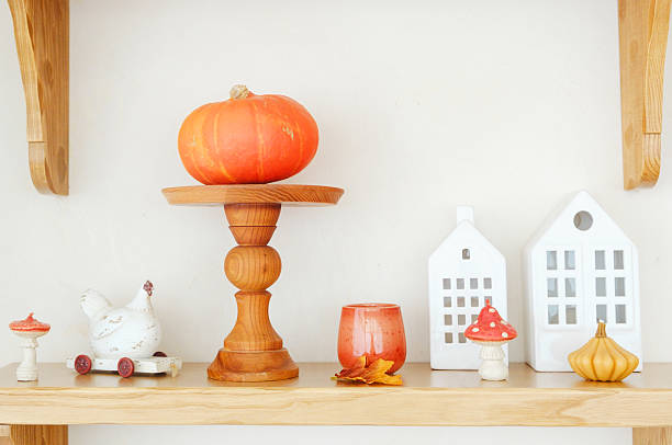 istock Autumn pumpkin and decorative gourds displayed with whimsical ceramic mushroom and white house lights. 2237511074