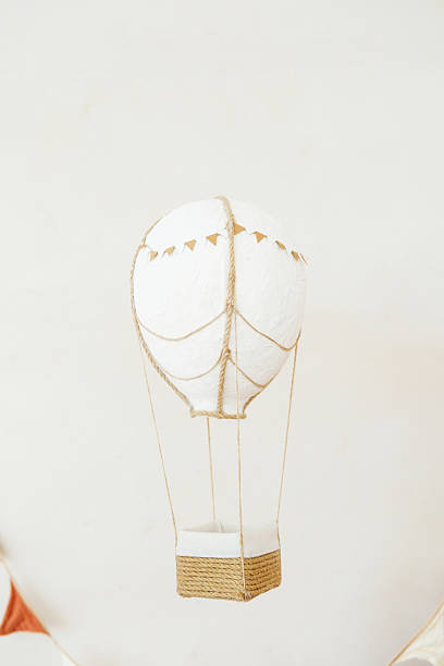 istock White balloon decoration with twine and fabric basket hangs against plain background 2237511075