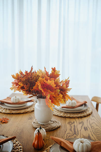 istock Autumn table setting with maple leaves and mini pumpkins on wood table 2237511086