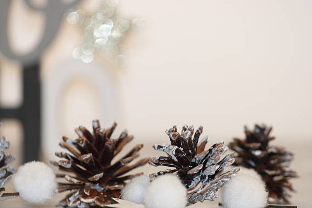 Red decorative Christmas baubles against white brick wall, festive holiday decor emphasizing seasonal spirit and classic ornament style