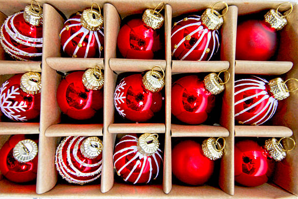 istock Red decorative Christmas baubles against white brick wall, festive holiday decor emphasizing seasonal spirit and classic ornament style 2237515667