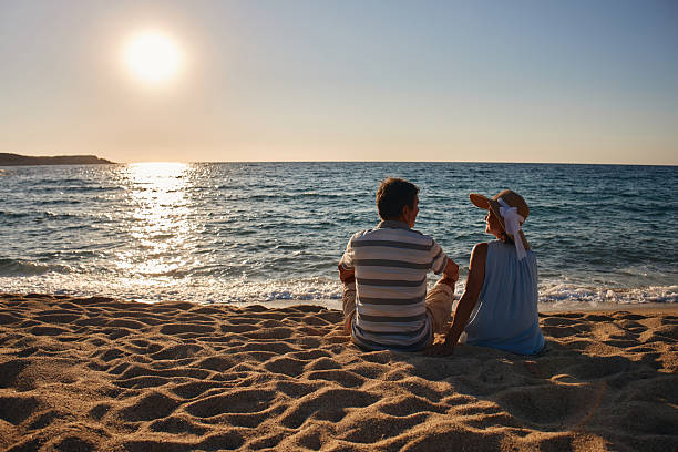 istock Senior couple enjoying sitting on the beach 2237516964