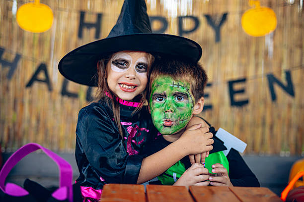 istock Happy children hugging and celebrating Halloween together 2237517765