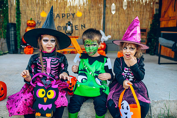 istock Kids in Halloween costumes with candy buckets 2237518098