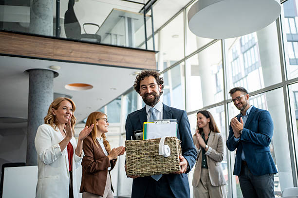 istock Businessman leaving office, colleagues clapping for farewell 2237519255