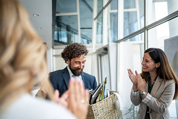 istock Business colleagues applauding man leaving office with box 2237519284