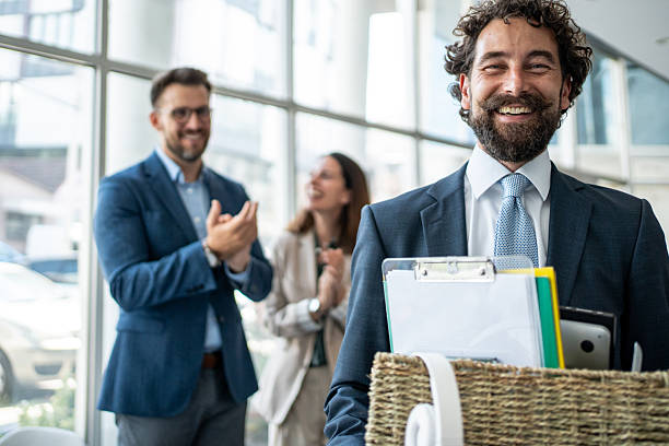 istock Happy man leaving office with box of personal items, colleagues clapping 2237519298