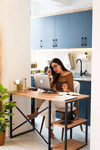 istock Woman working on laptop in home kitchen office 2237522722