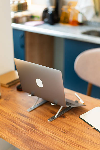 Laptop on desk in kitchen, home office working