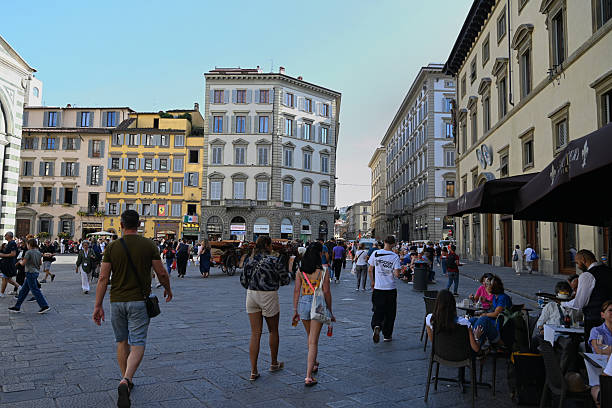 Florence, Italy, september 17, 2025 : Tourists in Piazza di San Giovanni in Florence