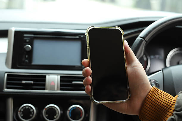 istock Driver searches for directions using mobile phone in car 2237524917