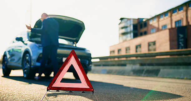 istock Warning sign, car breakdown and triangle on road with problem, fail or roadside assistance. Frustrated, back of person and reflective for highway safety, emergency or mechanical crisis outdoor 2237525685