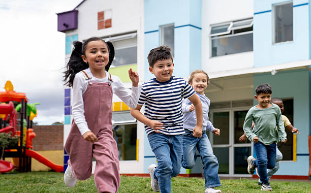 istock Happy group of children running while playing outdoors at the school 2237526760