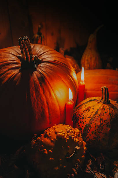istock Pumpkins and Gourds with Candles at Night 2237526815