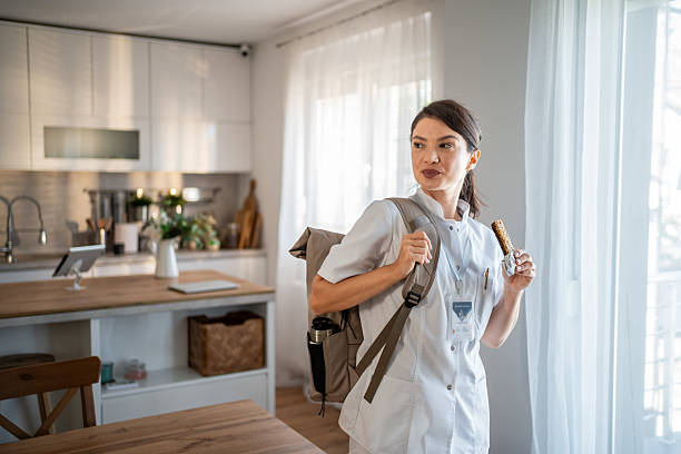 istock Female nurse eating snack bar leaving for work 2237526924