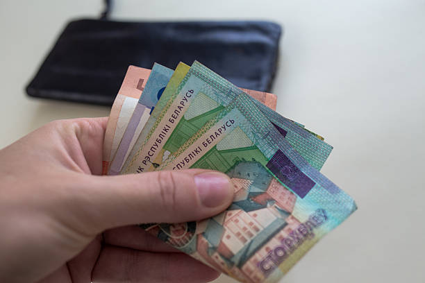 istock Hand holding Belarusian rubles with wallet in background 2237527179