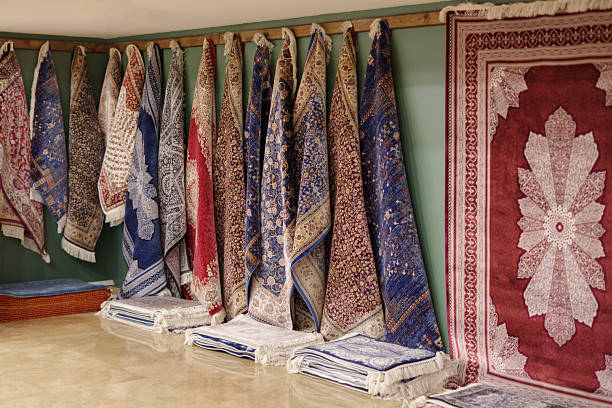 Avanos, Turkey - November 13, 2024: Shop with an array of carpets neatly arranged along walls, featuring vibrant, intricate designs in a colorful in the Armas Sentez factory called Avanos Hali located in central Anatolia, Turkey