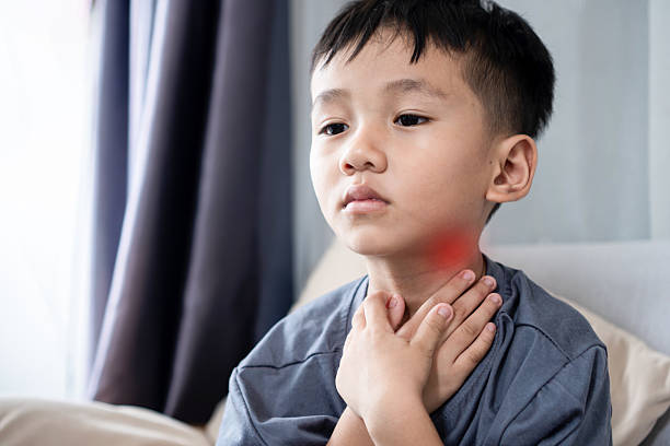 istock boy suffering from lymphadenitis, experiencing pain and swelling under the chin. 2237529469