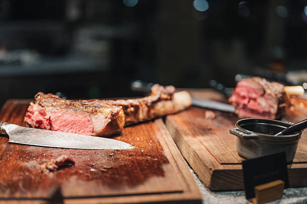 Grilled T-Bone steak served rich texture fine dining, gourmet cuisine, meat preparation, hospitality industry, and modern restaurant culture.
