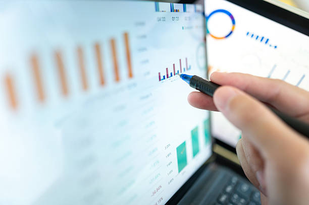 istock Close-up of hands using a stylus to analyze AI-powered financial data on a laptop screen algorithmic trading insights A professional reviews real-time market trends on a digital platform 2237531091