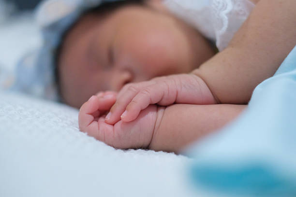 istock A newborn baby is lying on a bed. 2237533010