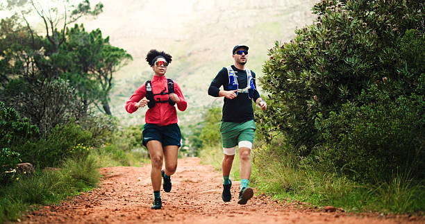 istock Hiking, running and training with couple in forest together for challenge, performance or workout. Exercise, fitness and space with hiker people outdoor in nature for development, hobby or journey 2237534423