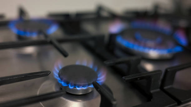 istock Burners lit in a gas kitchen stove, burning with blue flames, ready for cooking 2237540190