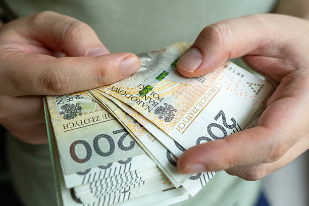 istock Counting Polish Zloty Banknotes by Hand 2237540300