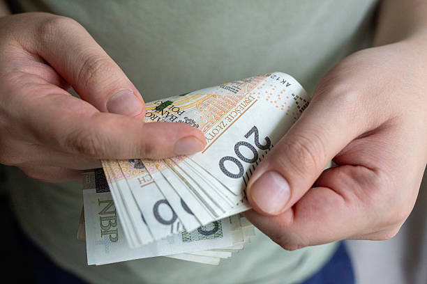 istock Person holding stack of Polish zoty banknotes 2237540351