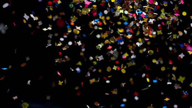 istock Falling colorful confetti on a black background, festive backdrop 2237540439